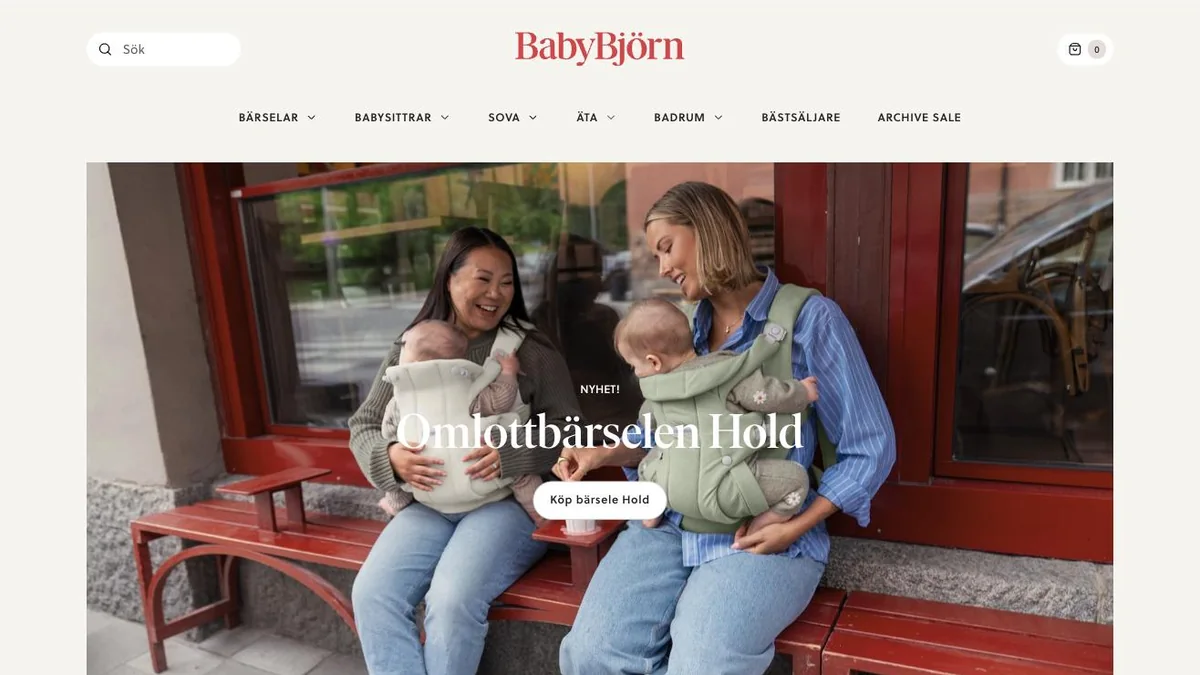 The BabyBjörn storefront, with two parents carrying babies in the new carrier